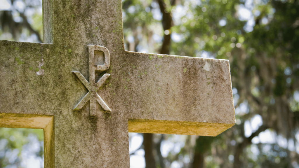 Chi-Rho symbol on weathered metal with a circular frame.

